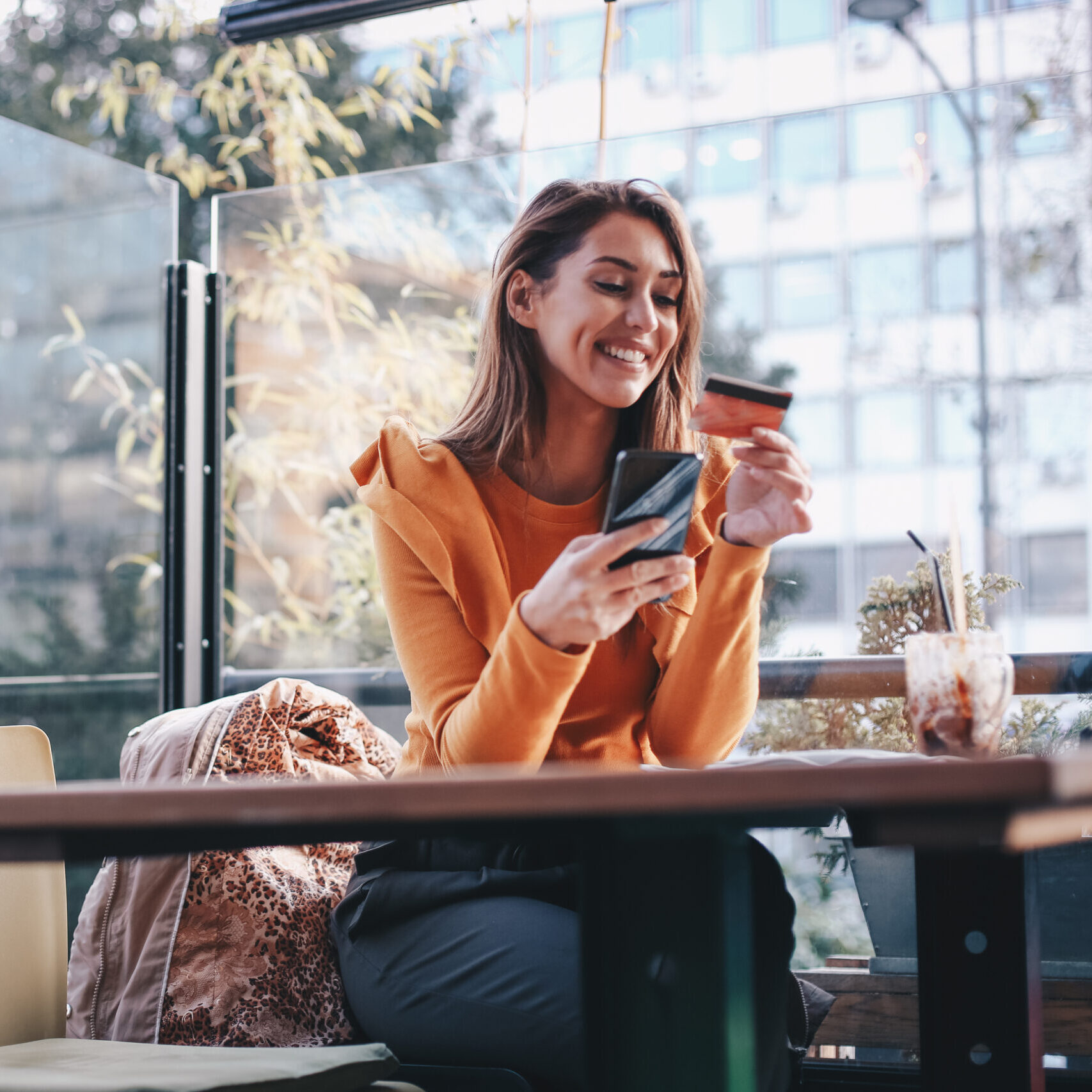 Young woman is buying online, using her mobile phone. COVID-19 concept.